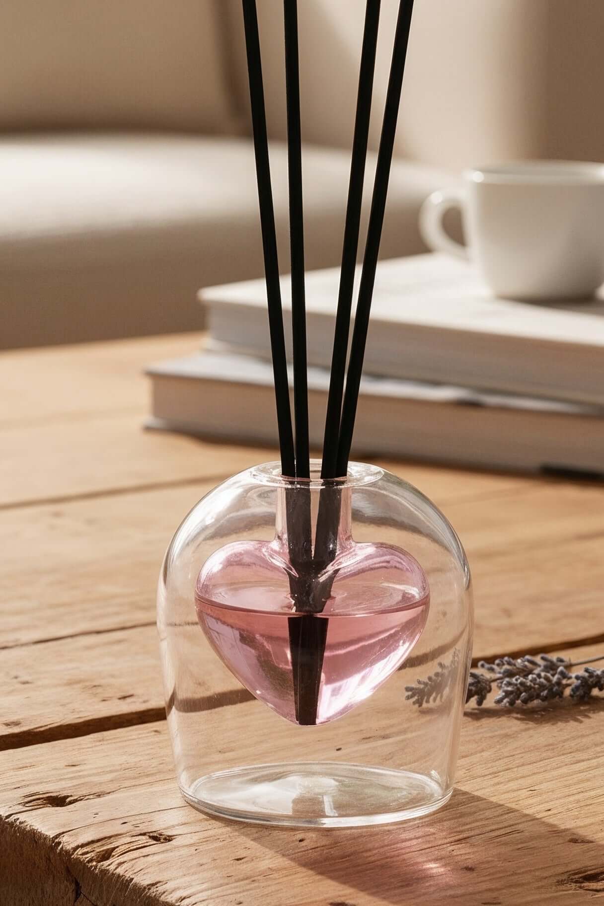 Diffuser with sticks on a wooden table in a cozy living room setting